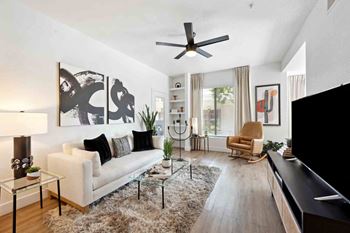 a living room with a couch and a ceiling fan